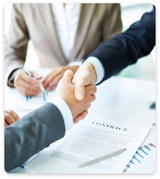 Two company employees shake hands after the contract is signed.